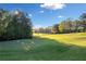 Scenic view of the golf course with lush green fairway and mature trees under a blue sky at 139 Thunder Ridge Ln, Acworth, GA 30101