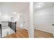 Hallway with wood flooring and access to a bathroom and utility room at 139 Thunder Ridge Ln, Acworth, GA 30101