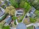 Stunning aerial view of lush landscaping, mature trees, circular driveway, and well-maintained homes in a desirable neighborhood at 1606 Nuthatch Ct, Marietta, GA 30062