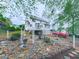 Landscaped backyard featuring rock garden, white arbor, shrubs, and mature trees at 1606 Nuthatch Ct, Marietta, GA 30062