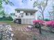 The backyard includes a bench, deck, lush landscaping, and mature trees at 1606 Nuthatch Ct, Marietta, GA 30062
