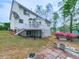 Exterior of home, yard with garden and bench seating, with stairs to deck at 1606 Nuthatch Ct, Marietta, GA 30062
