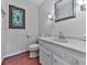 Elegant half-bathroom featuring custom stained glass window and white vanity at 1606 Nuthatch Ct, Marietta, GA 30062