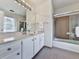 Well-lit bathroom featuring a vanity with a large mirror and a shower-tub combination at 1606 Nuthatch Ct, Marietta, GA 30062