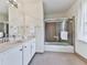 Well-lit bathroom featuring a vanity with a large mirror and a shower-tub combination at 1606 Nuthatch Ct, Marietta, GA 30062