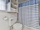 Bathroom with a toilet, shower with blue curtain, and shelf at 1606 Nuthatch Ct, Marietta, GA 30062