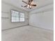 Bright bedroom with a ceiling fan, window, and neutral carpet at 1606 Nuthatch Ct, Marietta, GA 30062