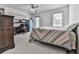 Bright bedroom with a ceiling fan, window, and a desk area at 1606 Nuthatch Ct, Marietta, GA 30062