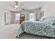 Bright primary bedroom featuring two large windows, carpet, and a ceiling fan at 1606 Nuthatch Ct, Marietta, GA 30062