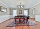 Traditional dining room with hardwood floors, area rug, and decorative wainscoting at 1606 Nuthatch Ct, Marietta, GA 30062