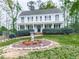 Stately two-story home with well-maintained landscaping, including flowering bushes at 1606 Nuthatch Ct, Marietta, GA 30062