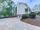 Two-story home featuring a long driveway leading to a two-car garage with manicured landscaping at 1606 Nuthatch Ct, Marietta, GA 30062