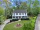 Two-story home with inviting curb appeal, mature trees, and a long driveway at 1606 Nuthatch Ct, Marietta, GA 30062