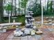 Backyard water feature with stone benches and a stone paved seating area at 1606 Nuthatch Ct, Marietta, GA 30062