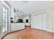 Kitchen view featuring white cabinets, breakfast bar, and hardwood flooring at 1606 Nuthatch Ct, Marietta, GA 30062