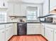 Kitchen featuring stainless steel appliances, solid surface countertops, and white cabinetry at 1606 Nuthatch Ct, Marietta, GA 30062