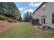 Expansive backyard featuring a patio, grassy lawn, and views of the home's exterior at 587 Jody Pl, Lilburn, GA 30047