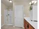 Clean bathroom featuring a large mirror, neutral walls, vanity, and glass door shower at 587 Jody Pl, Lilburn, GA 30047