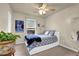 Bedroom featuring neutral walls, ceiling fan, ample natural light, and modern décor at 587 Jody Pl, Lilburn, GA 30047