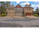 Attractive townhome exterior with brick facade, multi-car garages, dormer windows and well-maintained landscaping at 587 Jody Pl, Lilburn, GA 30047