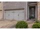 Spacious three-car garage featuring gray doors and decorative hardware at 587 Jody Pl, Lilburn, GA 30047