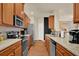 Modern kitchen with stainless steel appliances, granite countertops and ample cabinet space at 587 Jody Pl, Lilburn, GA 30047