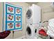 Convenient laundry area featuring stacked washer/dryer and storage shelving at 587 Jody Pl, Lilburn, GA 30047