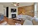 Living room with a fireplace, wood wall, and hardwood floors at 587 Jody Pl, Lilburn, GA 30047