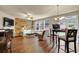 Open-concept living area featuring a fireplace, wood wall, and breakfast bar seating at 587 Jody Pl, Lilburn, GA 30047