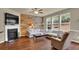 Cozy living room with fireplace, wood accent wall, and large windows at 587 Jody Pl, Lilburn, GA 30047
