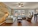 Inviting living room with hardwood floors, a wood accent wall, and lots of natural light at 587 Jody Pl, Lilburn, GA 30047