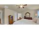 Bedroom featuring neutral walls, ceiling fan, and wooden furnishings with plenty of closet space at 587 Jody Pl, Lilburn, GA 30047