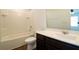 Bathroom featuring a tub-shower combination with white tiled walls and a dark wood vanity at 1837 Millstream Holw, Conyers, GA 30012