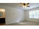 Large bedroom with ensuite bathroom access and features neutral carpet and natural light from the window at 1837 Millstream Holw, Conyers, GA 30012