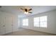 Bright bedroom with two large windows, a ceiling fan, and a spacious closet at 1837 Millstream Holw, Conyers, GA 30012