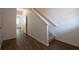 Inviting hallway features wood-look flooring and a staircase leading to upper level at 1837 Millstream Holw, Conyers, GA 30012