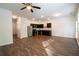 Open concept kitchen with stainless steel appliances and wooden floors, connecting to the living area at 1837 Millstream Holw, Conyers, GA 30012