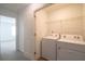 Convenient laundry room with a washing machine, dryer, and ample shelving for storage at 1837 Millstream Holw, Conyers, GA 30012