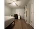 Well-lit bedroom with work area, fan, and a bookshelf at 2692 Briaroak Dr, Duluth, GA 30096