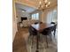 Open-concept dining room featuring modern chandelier and flows to the living room at 2692 Briaroak Dr, Duluth, GA 30096