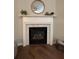 Cozy living room fireplace with a marble tile border and wood floors at 2692 Briaroak Dr, Duluth, GA 30096