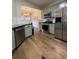 Kitchen featuring stainless steel appliances, wood floors, and pastel-colored cabinets at 2692 Briaroak Dr, Duluth, GA 30096