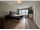 Spacious main bedroom with hardwood floors, large window and a king bed at 2692 Briaroak Dr, Duluth, GA 30096