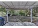 Backyard with covered patio, a peek of the lake, and mature shade trees at 3081 Frankie Ln, Duluth, GA 30096