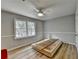A bright bedroom with a ceiling fan, a large window, and wood flooring at 3081 Frankie Ln, Duluth, GA 30096
