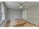 A bright bedroom with a ceiling fan, a large window, and wood flooring at 3081 Frankie Ln, Duluth, GA 30096