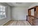 Bedroom with a large window, light-colored floors, and a vintage wooden dresser at 3081 Frankie Ln, Duluth, GA 30096