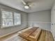 A bright bedroom with a ceiling fan, a large window, and wood flooring at 3081 Frankie Ln, Duluth, GA 30096