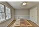 A bright bedroom with a ceiling fan, two windows, and wood flooring at 3081 Frankie Ln, Duluth, GA 30096