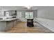 Open floorplan with dining area with wainscoting and hardwood floors, adjacent to the renovated kitchen at 3081 Frankie Ln, Duluth, GA 30096